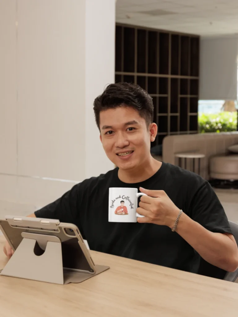 t-shirt-mockup-featuring-a-happy-man-with-a-coffee-mug-working-on-his-tablet.