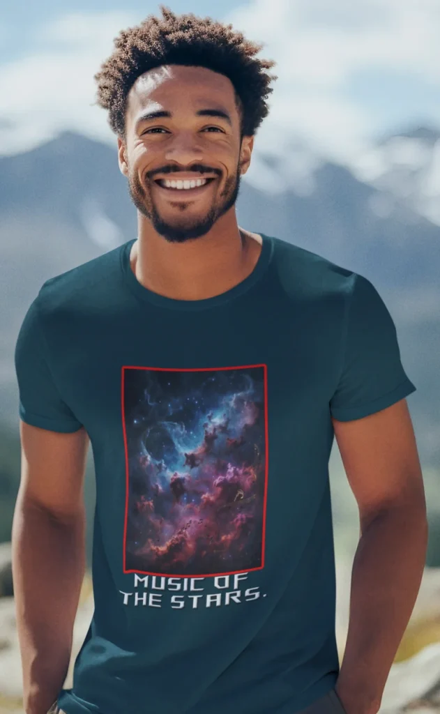 A-smiling-man-wearing-a-t-shirt-at-the-top-of-a-mountain.