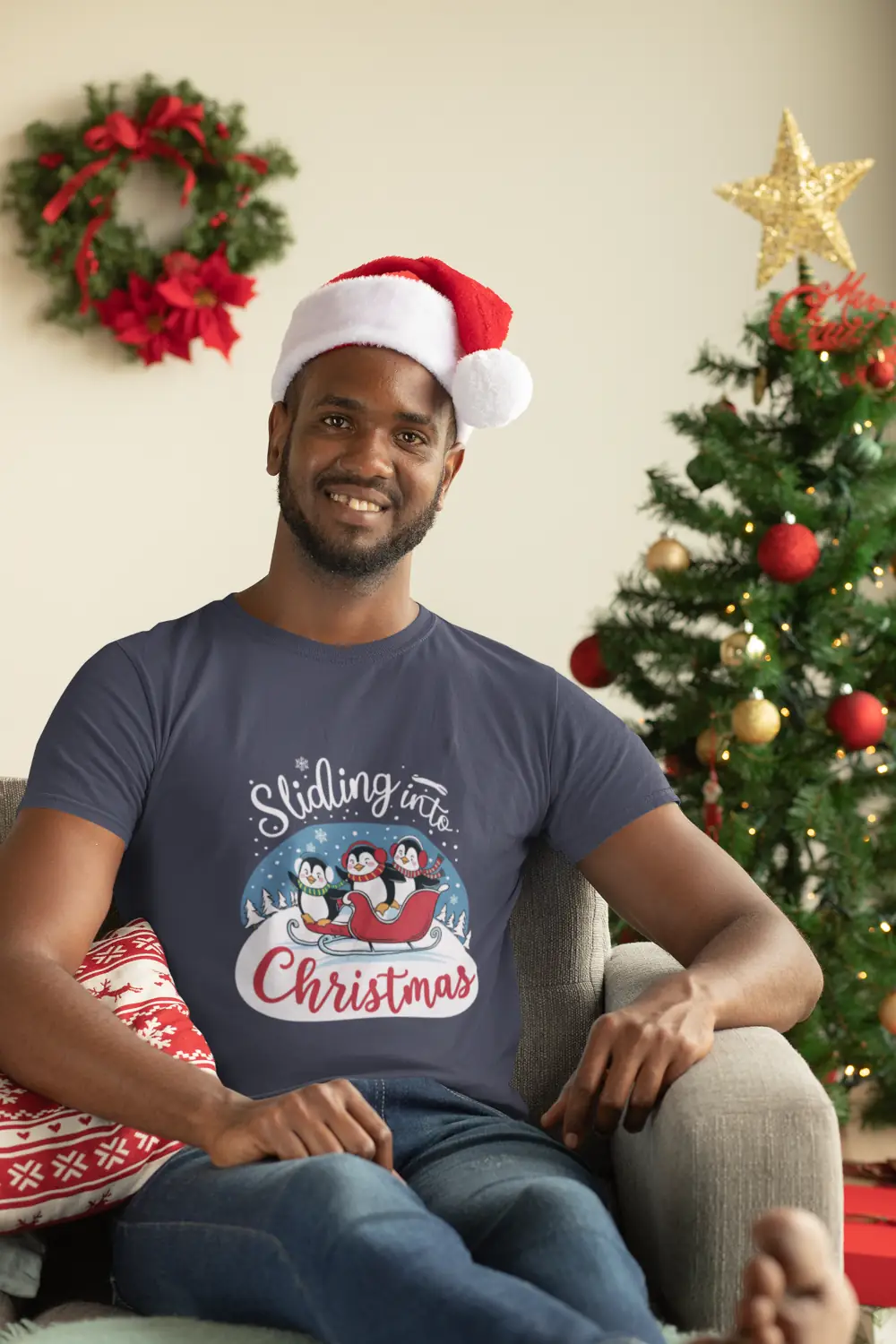 mockup-of-a-man-with-a-crewneck-t-shirt-sitting-next-to-a-christmas-tree